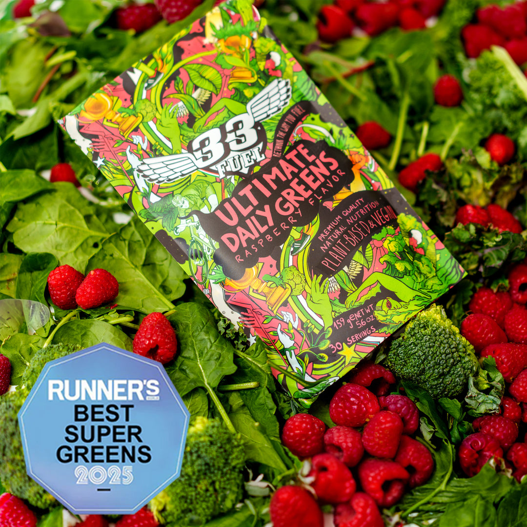 Greens powder  Ultimate Daily Greens' surrounded by fresh vegetables and berries. Award Runner's world BEST SUPER GREENS 2025